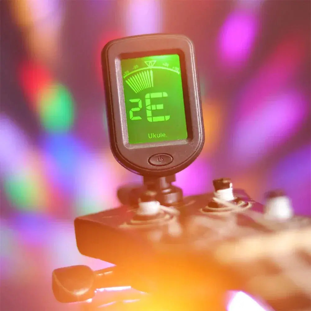Digital guitar tuner on headstock with bright colorful background lights